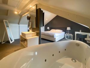 uma casa de banho com banheira e um quarto em Best Western Le Cheval Blanc -Vue sur le port-plein centre ville em Honfleur