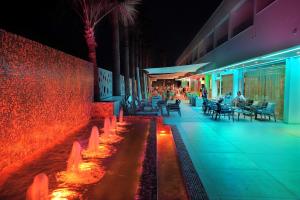 a row of benches in front of a building at Nelia Beach Hotel & Spa in Ayia Napa