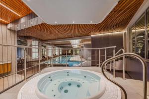 a jacuzzi tub in a building with two pools at Radisson Blu Daugava Hotel, Riga in Rīga