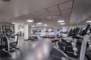 a gym with several treadmills and cardio machines at Radisson Blu Daugava Hotel, Riga in Rīga