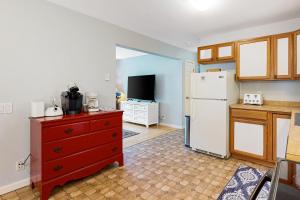 a kitchen with a red dresser and a white refrigerator at Electric Mountain in West Townshend