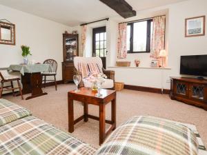 a living room with two beds and a tv at 1 Bed in Lyme Regis 90145 in Lyme Regis