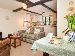 a living room with a couch and a table at 1 Bed in Lyme Regis 90145 in Lyme Regis