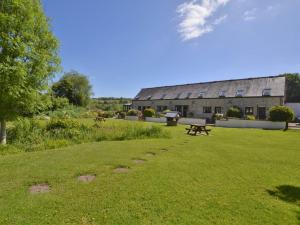a building with a picnic table in a grass field at 1 Bed in Lyme Regis 90145 in Lyme Regis