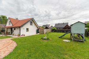 a yard with a house and a playground at Idyllic holiday home - relaxation place in Leibnitz