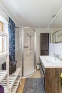 a bathroom with a shower and a sink and a tub at Idyllic holiday home - relaxation place in Leibnitz