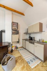 a kitchen with white cabinets and a counter top at Idyllic holiday home - relaxation place in Leibnitz