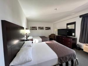 Postel nebo postele na pokoji v ubytování Hotel GH Guaparo Suites