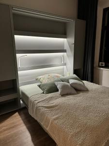 a bed with two pillows on it in a bedroom at Gäste-Appartements Morgensonne & Sonnenschein in Dresden