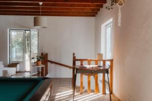 a living room with a table and a pool table at NaNa House Ericeira - Yoga & Surf in Santo Isidoro
