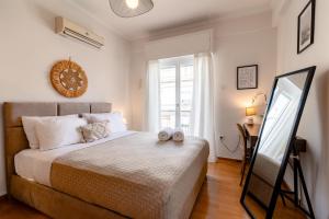 a bedroom with a bed with a mirror and a desk at Exarchia Artistic getaway for groups in Athens
