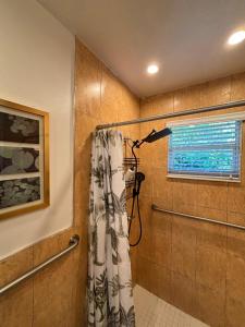 a bathroom with a shower with a shower curtain at Deluxe Room in best location Miami - Private Parking, Laundry and Luggage Storage in Miami