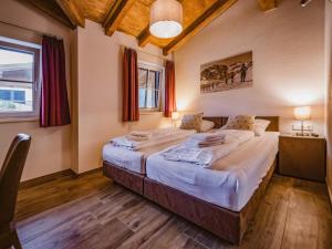 a bedroom with two beds in a room at Lodge Elise in Wald im Pinzgau