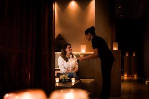 a man standing next to a woman in a living room at Dubai Marriott Harbour Hotel And Suites in Dubai