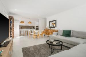 a living room with a couch and a table at 13B King Street in Port Macquarie