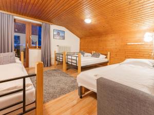 a bedroom with two beds and a wooden ceiling at Grieswirt L in Itter