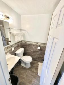a bathroom with a toilet and a sink at Royal Lodge in Coalinga