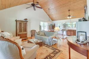 a living room with a couch and a table at Charming Lawley Cottage: Deck, Fire Pit & Yard! in Lawley