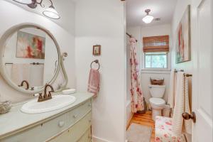 a bathroom with a sink and a mirror at Charming Lawley Cottage: Deck, Fire Pit & Yard! in Lawley