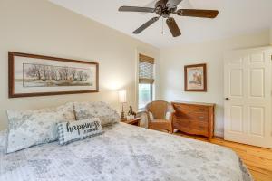 a bedroom with a bed and a ceiling fan at Charming Lawley Cottage: Deck, Fire Pit & Yard! in Lawley