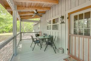 a porch with a table and chairs on it at Charming Lawley Cottage: Deck, Fire Pit & Yard! in Lawley +23 photos