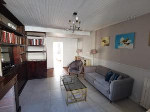 a living room with a couch and a table at Maison de charme-Castillon-St-Emilion in Saint-Magne-de-Castillon