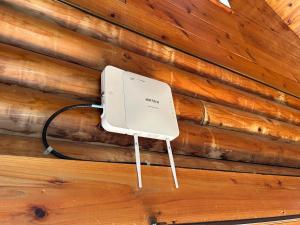 a wall with a white phone on a wooden wall at Tokashiki Guest House in Tokashiki