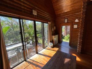 an empty room with a large glass door to a porch at Tokashiki Guest House in Tokashiki