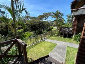 a view of a garden from the balcony of a house at Tokashiki Guest House in Tokashiki