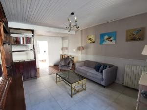a living room with a couch and a chair at Maison de charme-Castillon-St-Emilion in Saint-Magne-de-Castillon