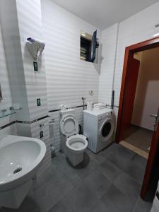 a bathroom with a toilet and a sink at Serenity at Sveti Stefan in Sveti Stefan +20 photos
