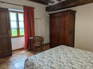 a bedroom with a bed and a desk and a window at Gîte Lorcy, 3 pièces, 5 personnes - FR-1-590-40 in Lorcy