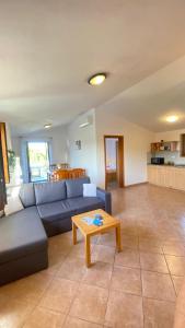 a living room with a blue couch and a table at Family friendly house with a swimming pool Krmed, Central Istria - Sredisnja Istra - 23175 in Bale