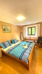a bedroom with a large bed with blue sheets at Family friendly house with a swimming pool Krmed, Central Istria - Sredisnja Istra - 23175 in Bale