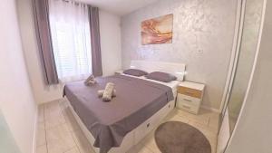 a small bedroom with a bed and a window at Apartments with a parking space Promajna, Makarska - 23181 in Promajna