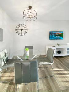 a dining room with a glass table and chairs at Prime location! Upscale, spacious 2BR-2 full BA Condo in Winston-Salem +10 photos