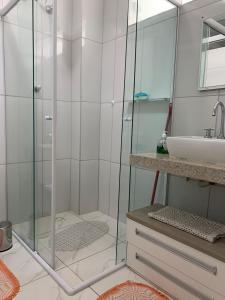 a bathroom with a shower and a sink at Beautiful condo by the shore in Santos