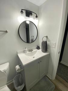 a bathroom with a sink and a mirror at Prime location! Upscale, spacious 2BR-2 full BA Condo in Winston-Salem
