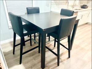 a black dining table with four chairs in a kitchen at Queen Suite with Wifi with Hot Tub Room 5 in Atlanta