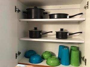 two pots and pans on shelves in a kitchen at The Man Cave - Fort Lauderdale Free - Laundry - Parking - Bbq Grill in Fort Lauderdale