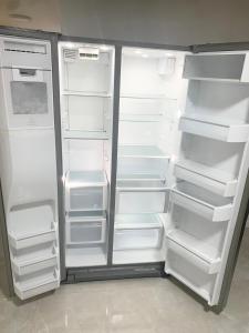 an empty refrigerator with its doors open in a kitchen at The Man Cave - Fort Lauderdale Free - Laundry - Parking - Bbq Grill in Fort Lauderdale