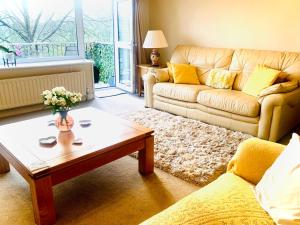 a living room with a couch and a coffee table at Tilly Cottage - overlooking Pendle Hill in Barrowford