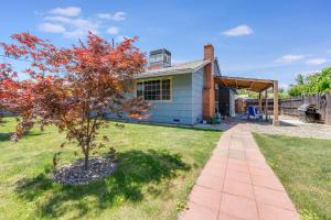 a small house with a tree in the yard at Charming 2-Bedroom Home With Private Office and Backyard in Rancho Cordova