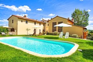 a house with a swimming pool in the yard at Holiday Home Casa Riccardo in Montespertoli