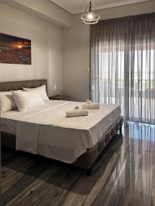 a bedroom with a large bed and a large window at SKYLINE Fine Living in Nei Poroi