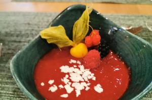 a green bowl of red sauce with berries and cheese at Holiday Inn - Osnabrück by IHG in Osnabrück +86 photos