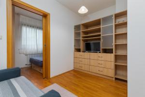 a living room with a tv and a large closet at Apartments with a parking space Zagreb - 22137 in Zagreb