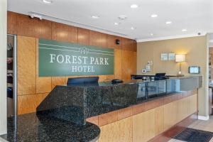 a hotel lobby with a forest park hotel sign at Forest Park Hotel in Clifton Heights