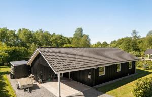 a black shed with a pitched roof at Stunning Home In Farsø With Sauna in Farsø +12 photos