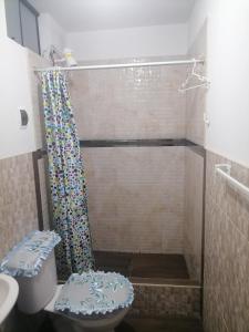 a bathroom with a shower with a toilet and a sink at Departamento-Bolognesi B1 in Chiclayo